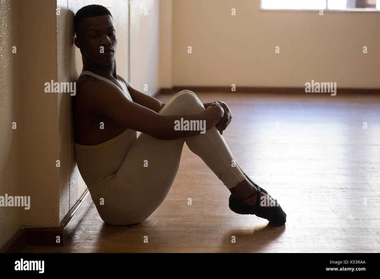 Depressed ballerino sitting in the studio Stock Photo