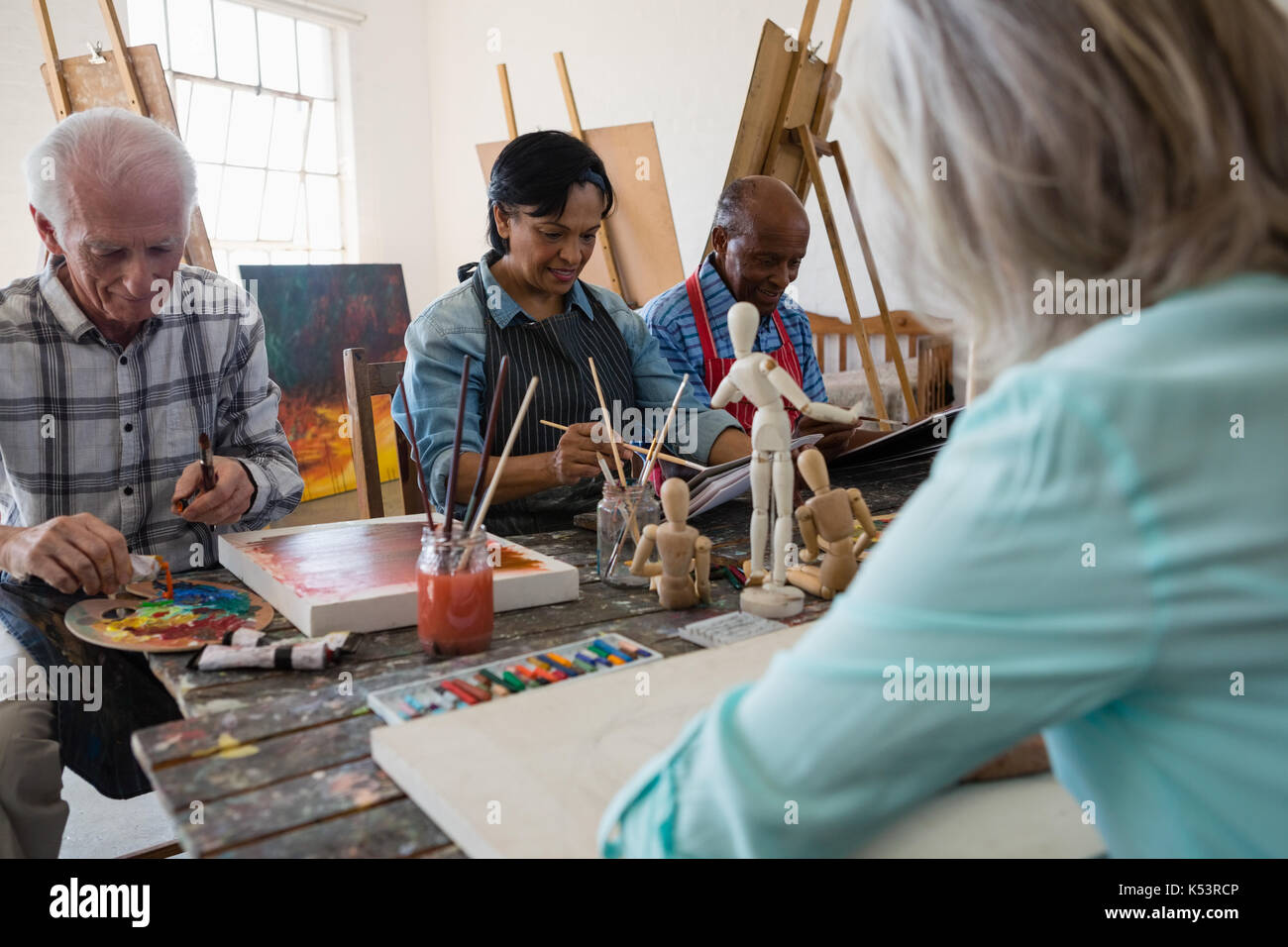 Senior friends painting on canvas in art class Stock Photo Alamy