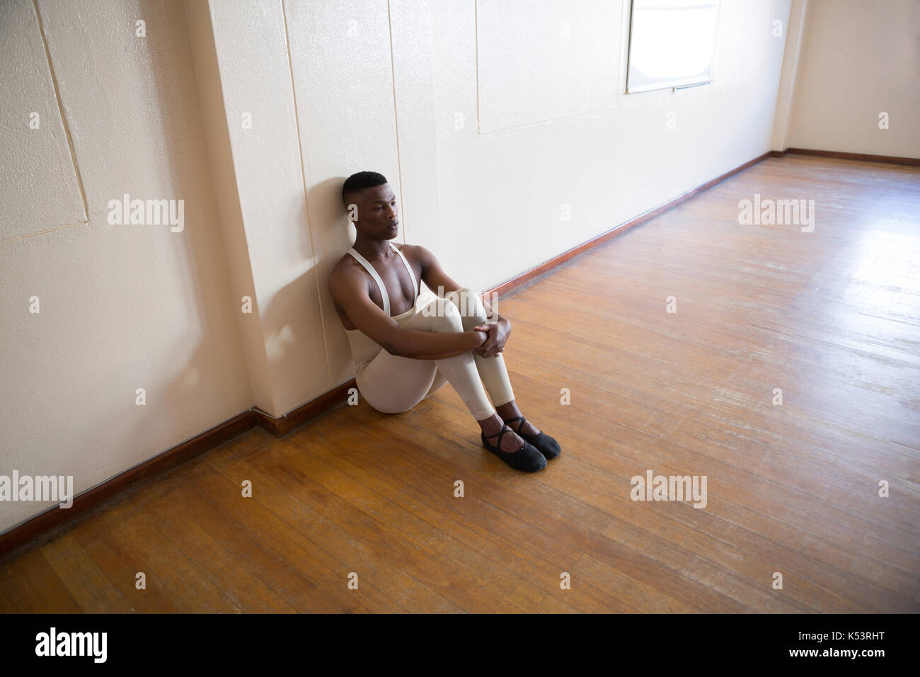 Depressed ballerino sitting in the studio Stock Photo