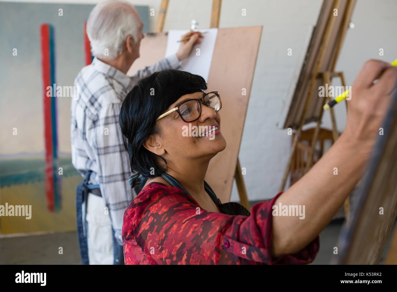 High angle view of senior male and female artists painting while in art class Stock Photo