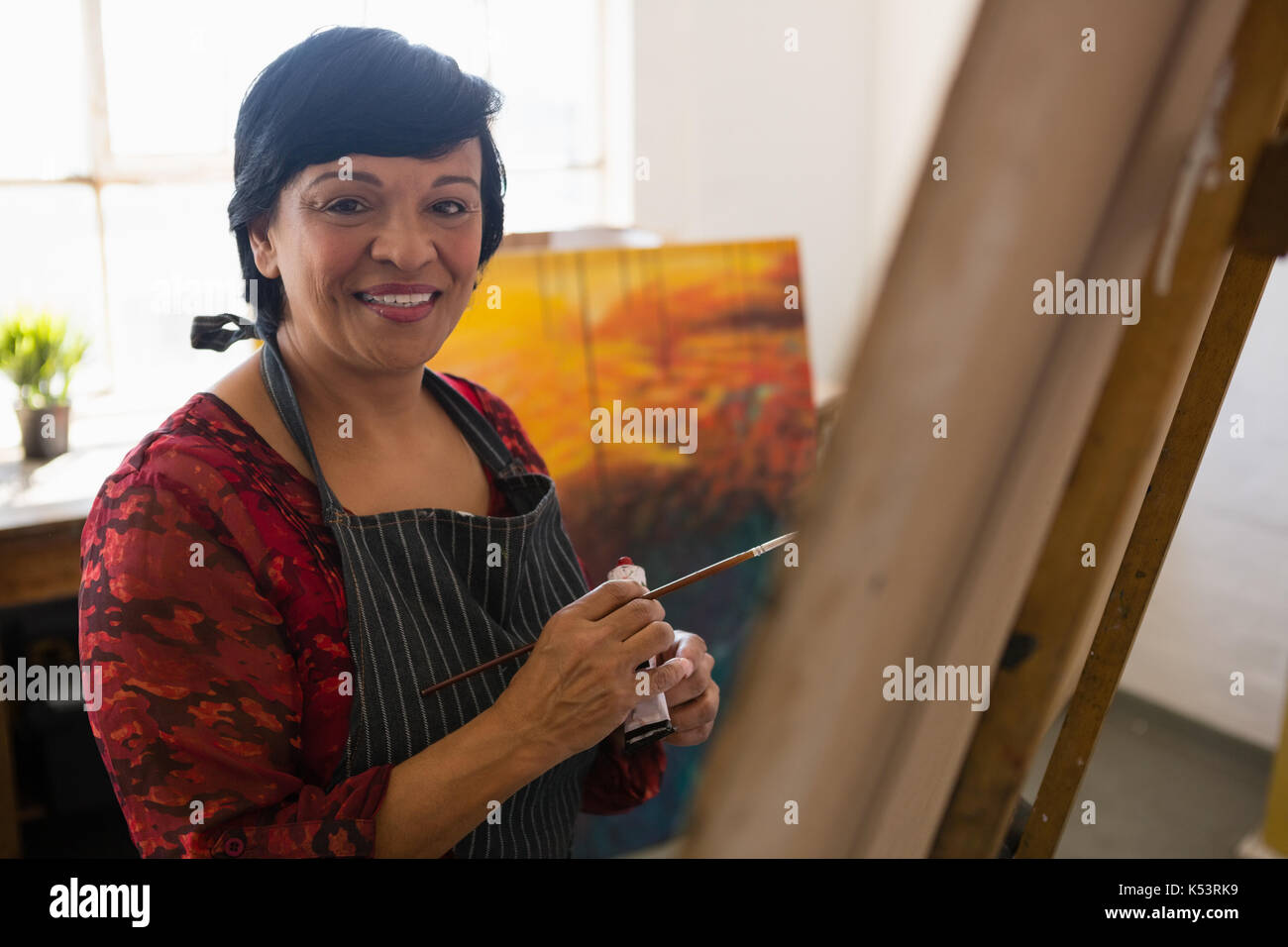 Close up portrait of senior woman painting in art class Stock Photo - Alamy