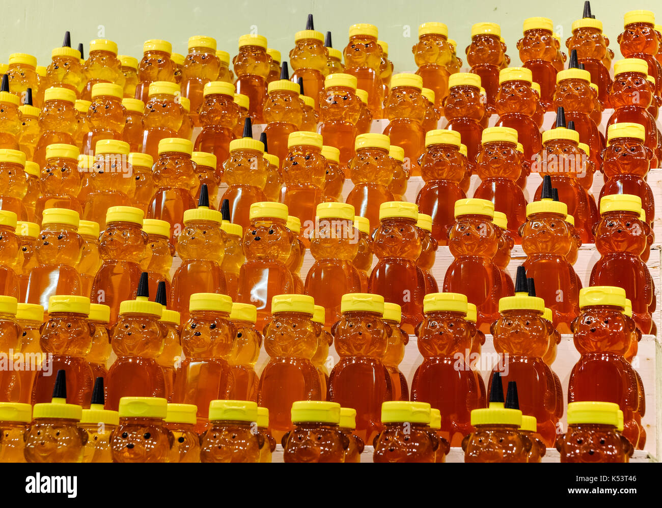 Bear-shaped honey jars on shelves. Stock Photo