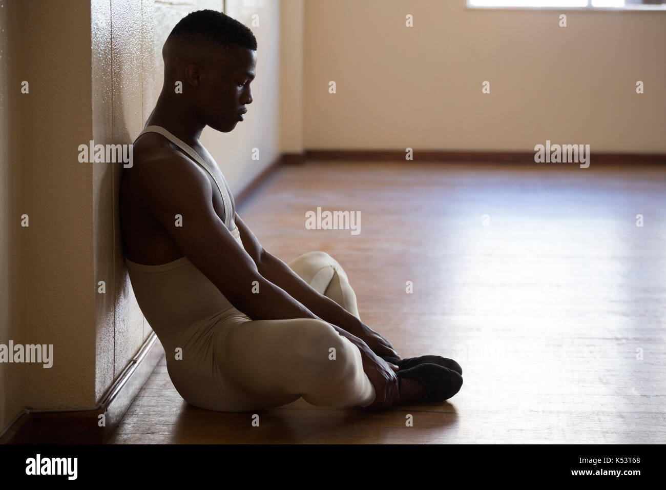 Depressed ballerino sitting in the studio Stock Photo