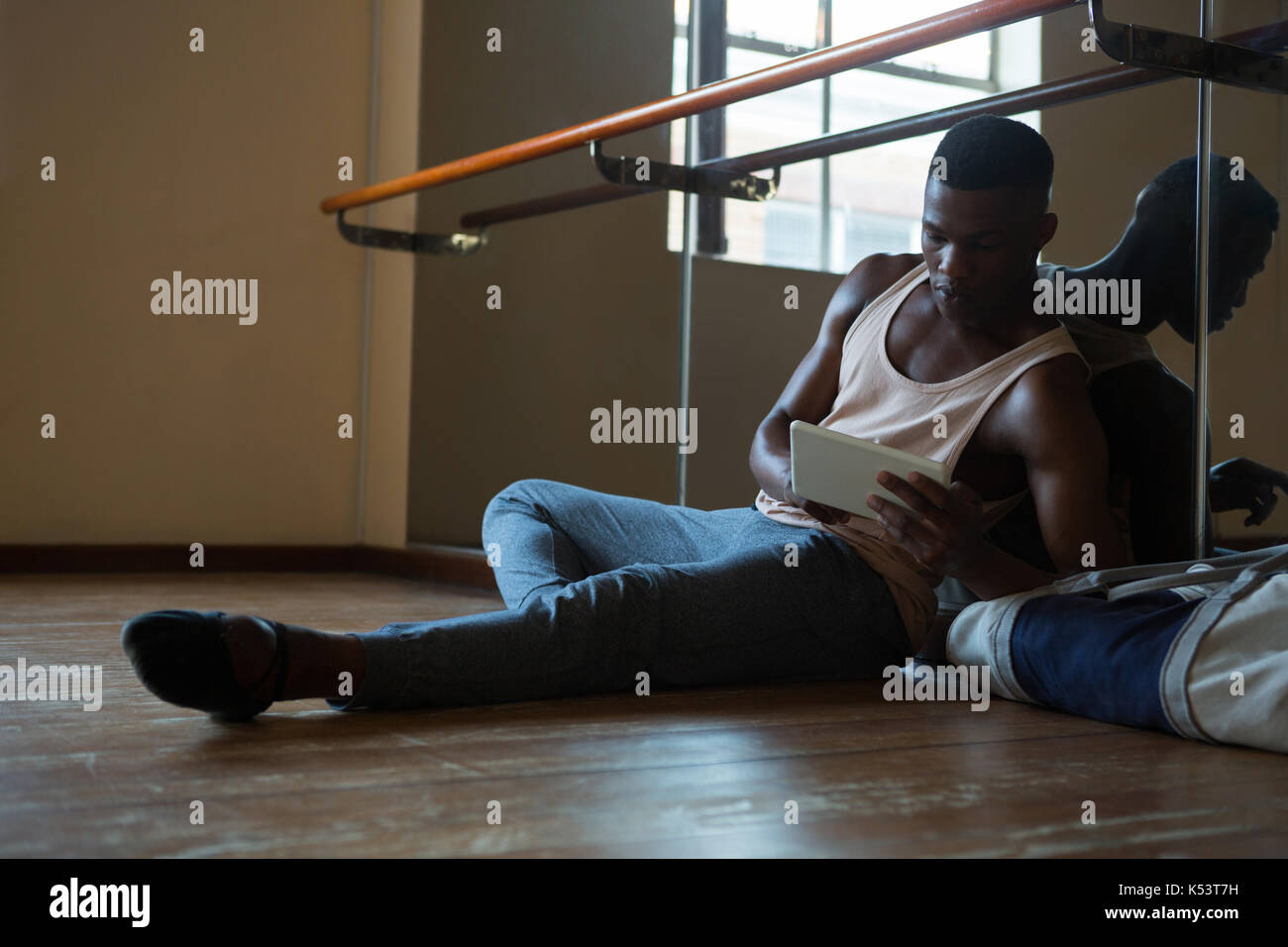 Ballerino using digital tablet in the studio Stock Photo