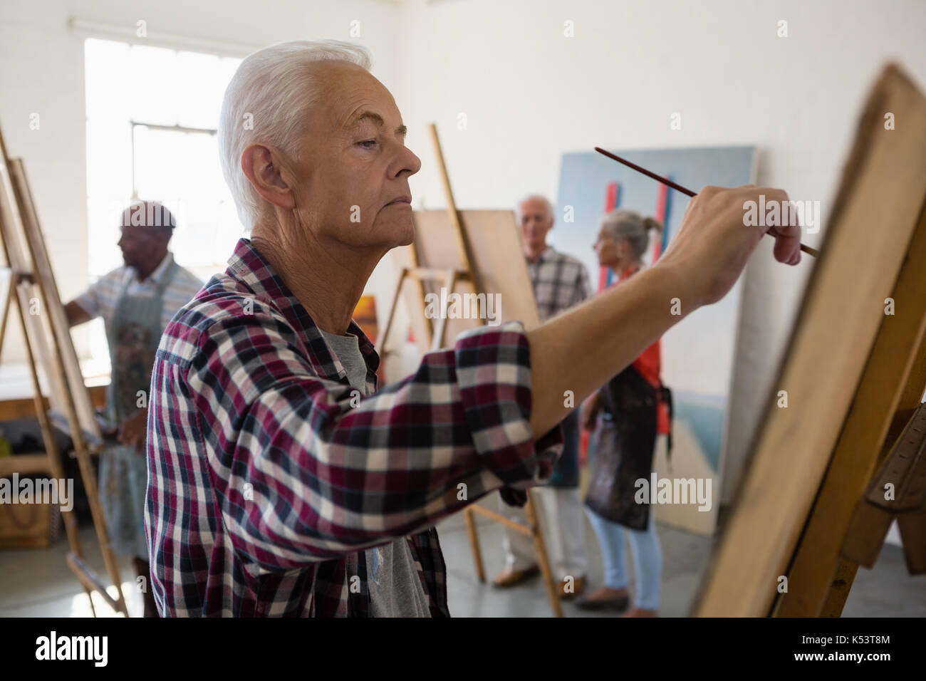 Side view senior man painting hi-res stock photography and images - Alamy