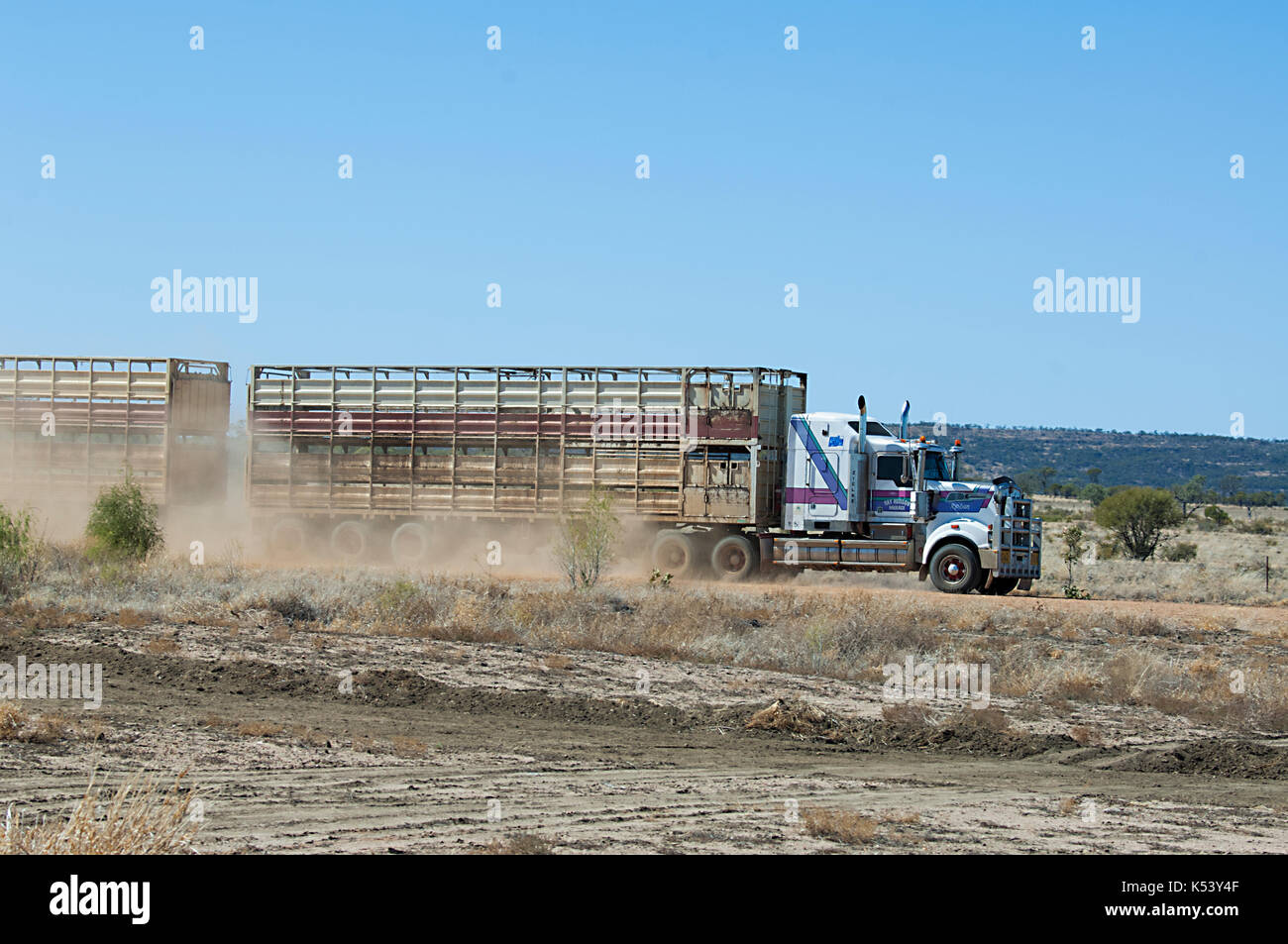 Cattle truck driving through the Outback and sending dust flying, Hughenden, Queensland, QLD, Australia Stock Photo