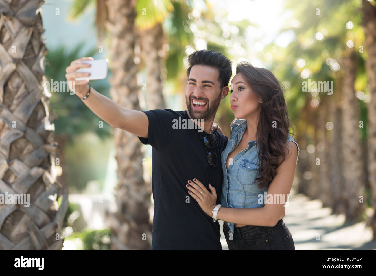Dark-haired handsome boyfriend posing for selfie with his appealing  girlfriend Stock Photo - Alamy