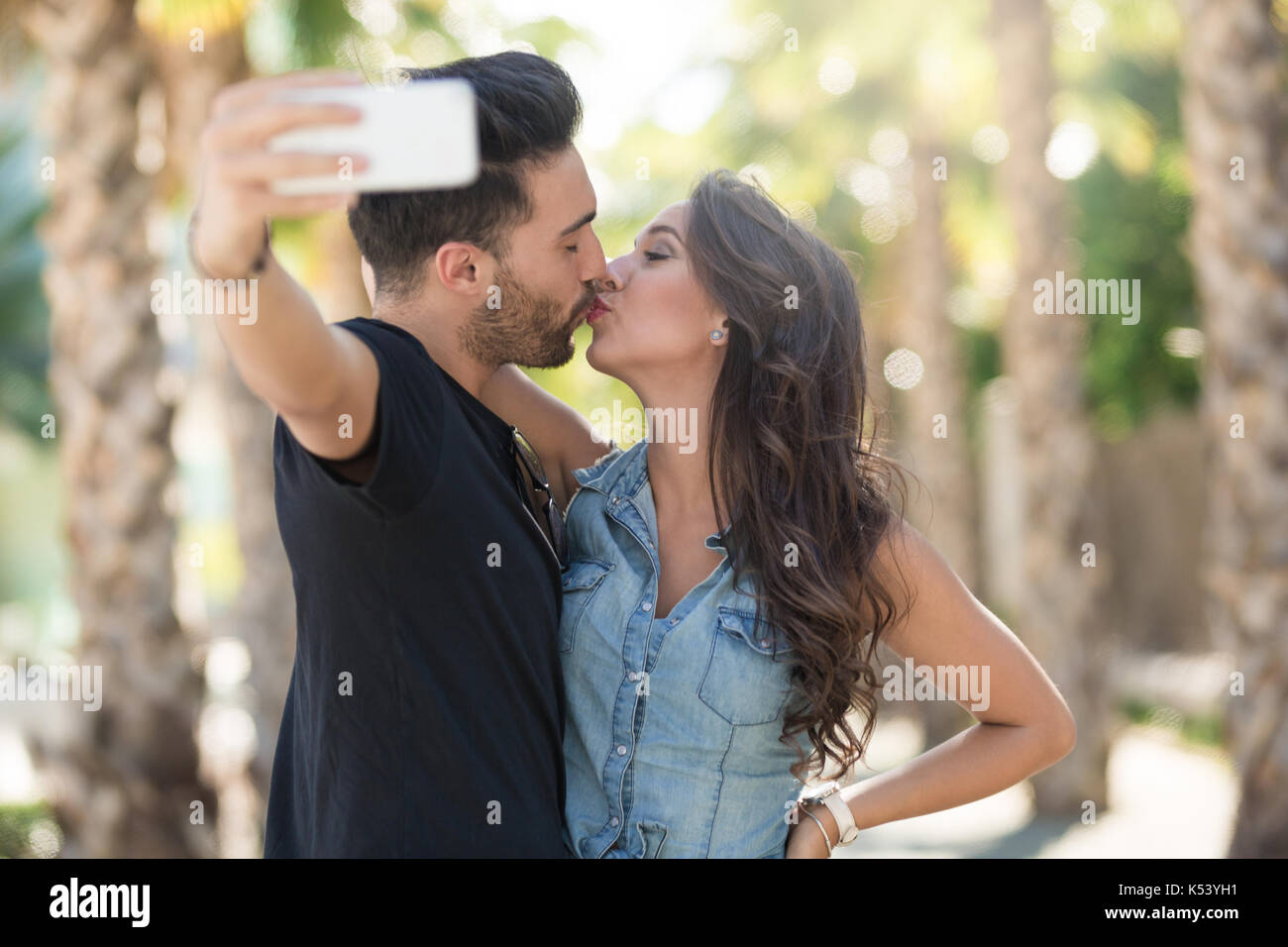 Young Attractive African American Couple Pose for Selfie Pose with Smart  Phone Stock Photo - Image of caucasian, lifestyle: 109855292