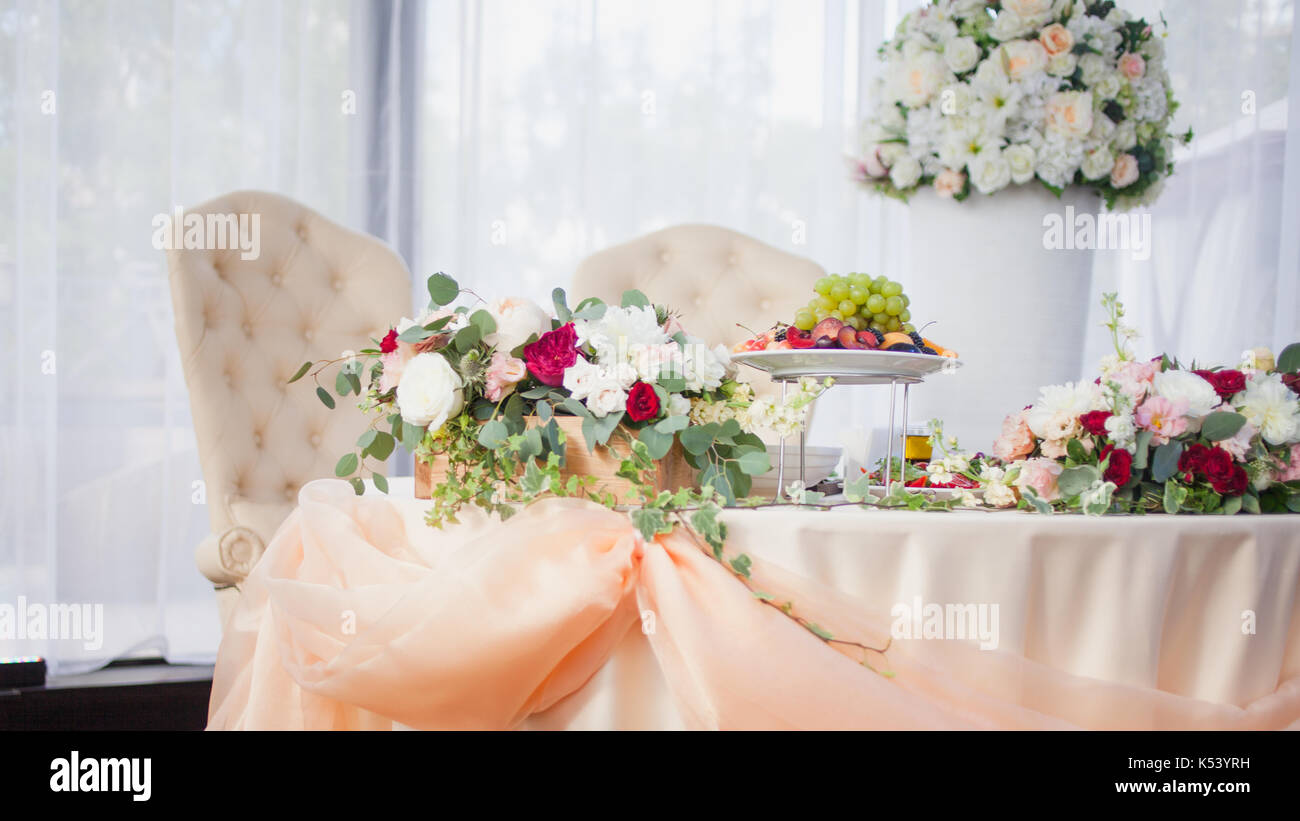 Table of the bride and groom in the restaurant. Wedding decor Stock