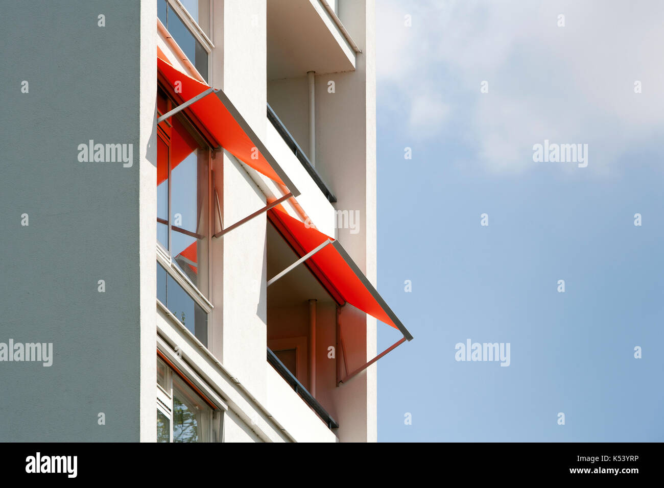 Orange awnings on a white apartment block Stock Photo