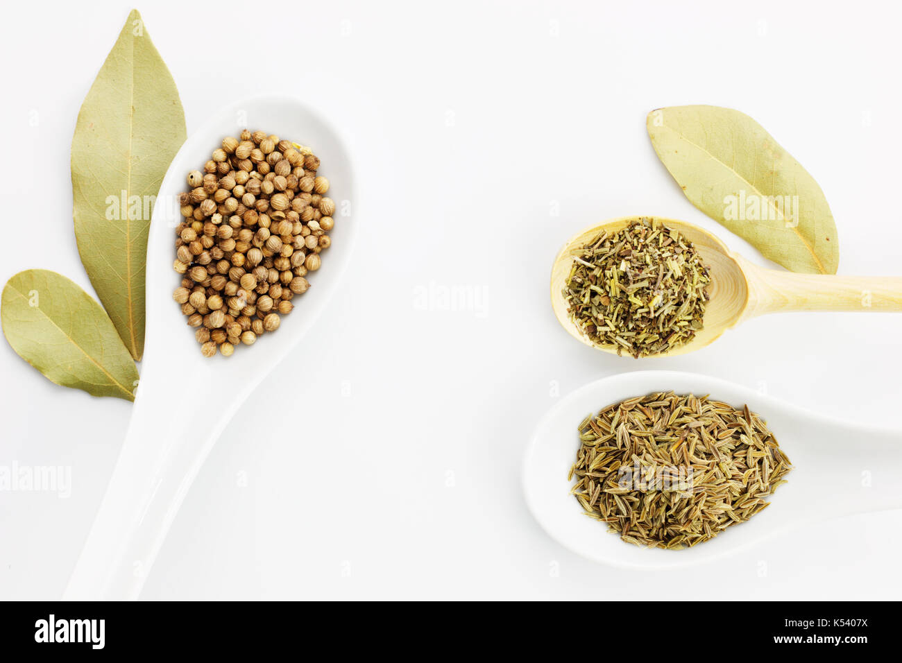 Various spices oregano, coriander seeds, bay leaves and cumin seeds
