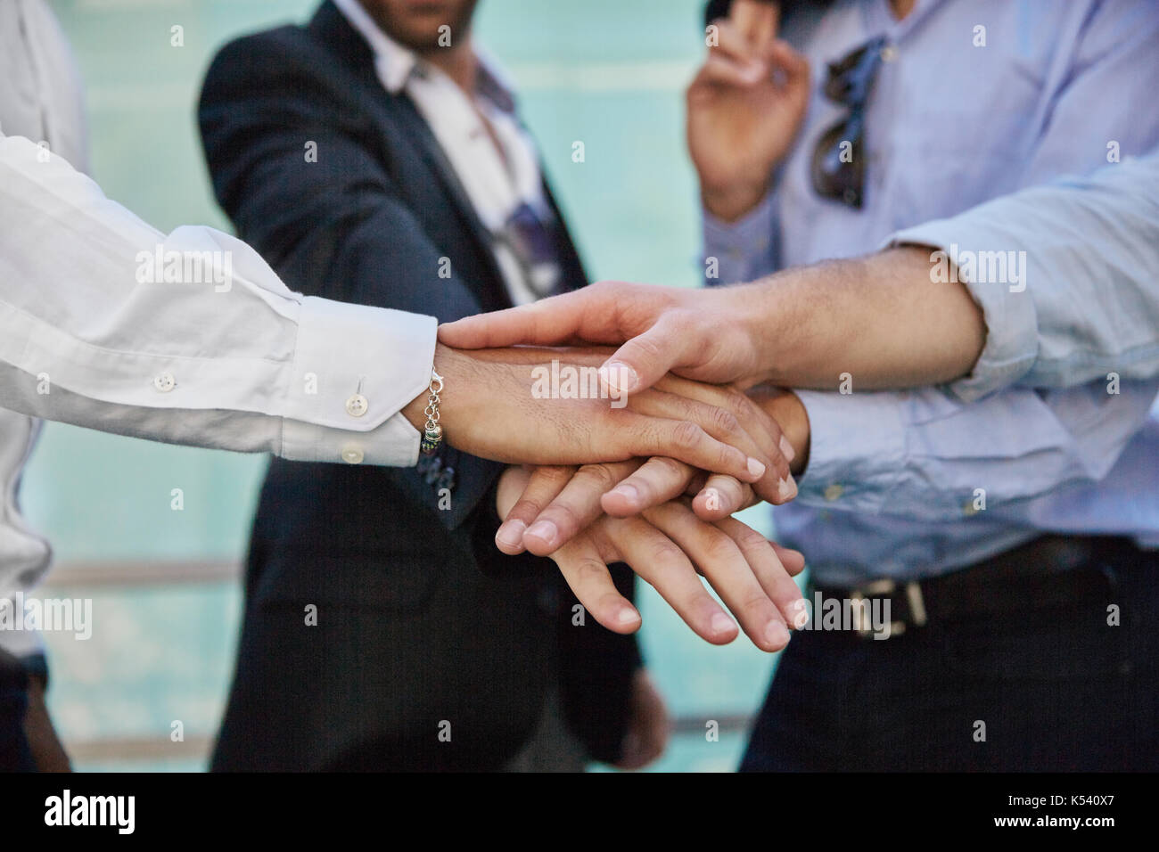 Close up on men hands holding together in gesture of unity Stock Photo