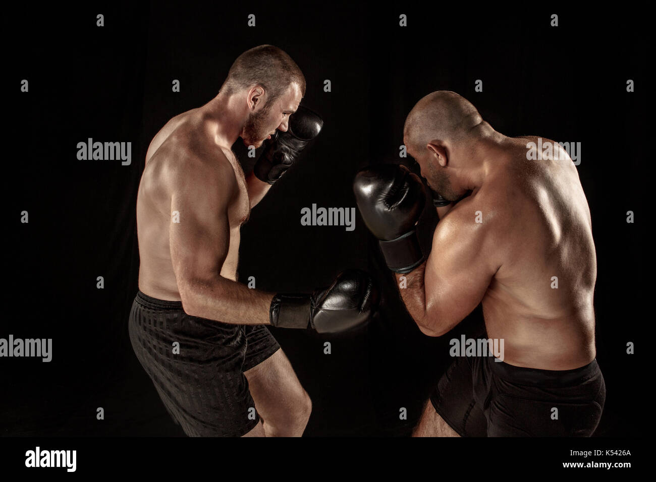 Two muscular men fighting, bodybuilders punching each other, training