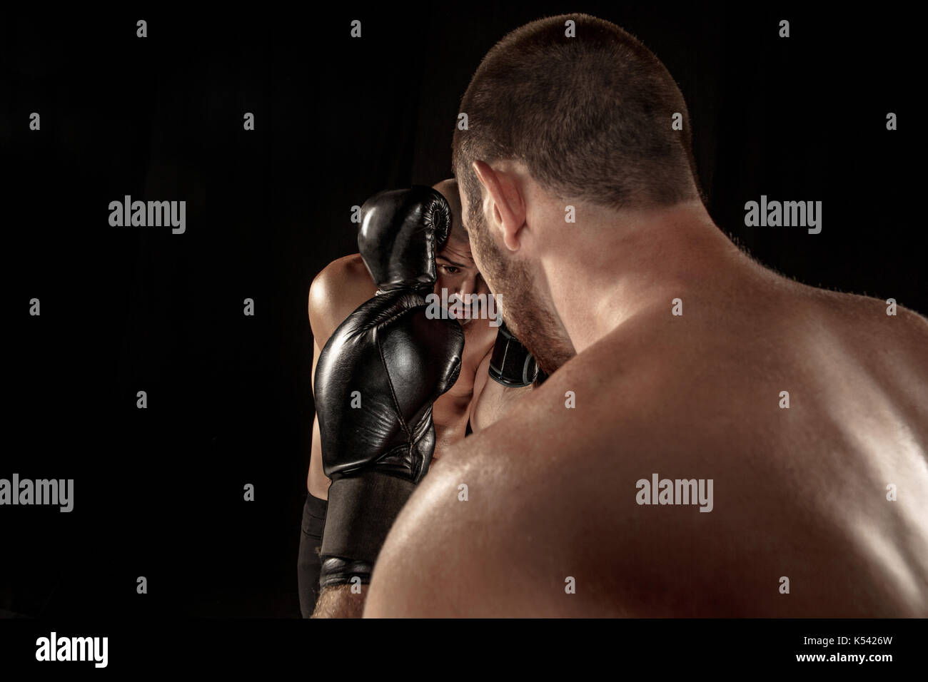 Two muscular men fighting, bodybuilders punching each other, training