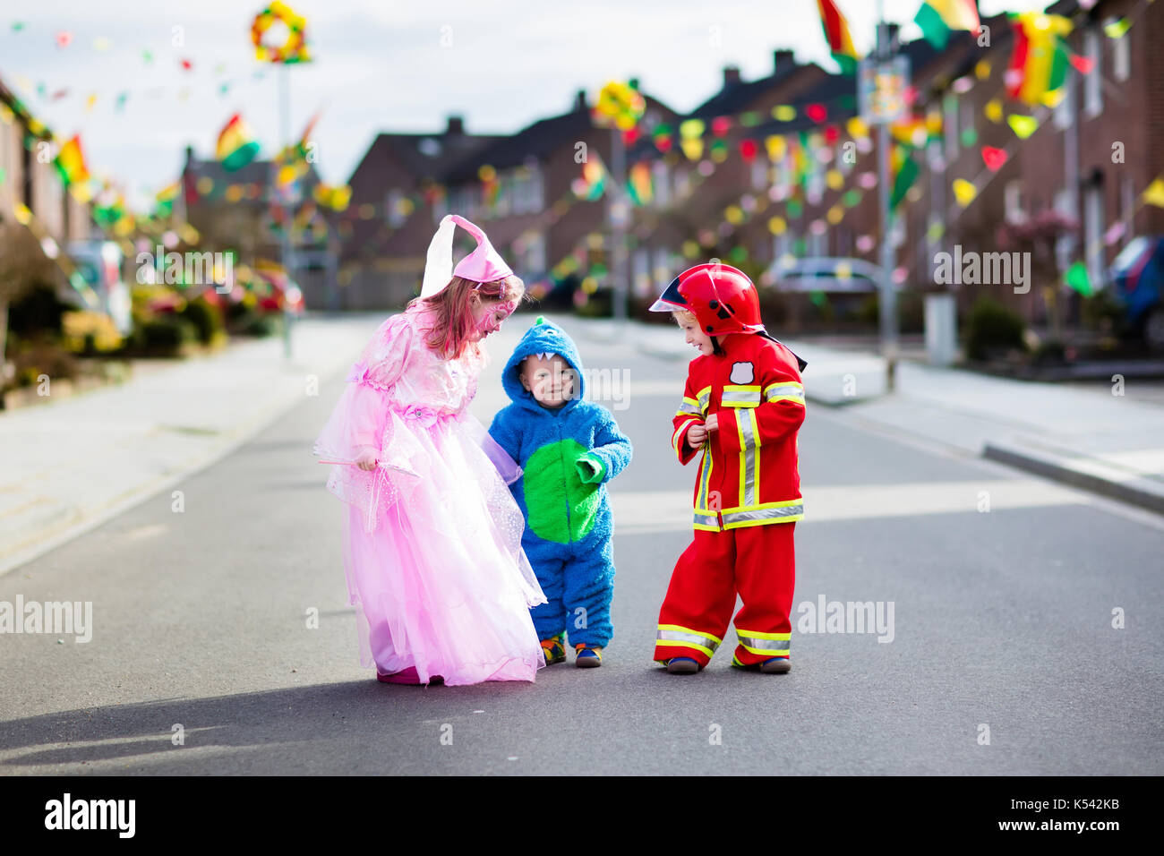 Kids on Halloween trick or treat. Children in Halloween costumes with ...