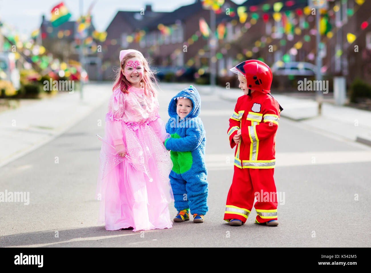 Kids on Halloween trick or treat. Children in Halloween costumes with ...