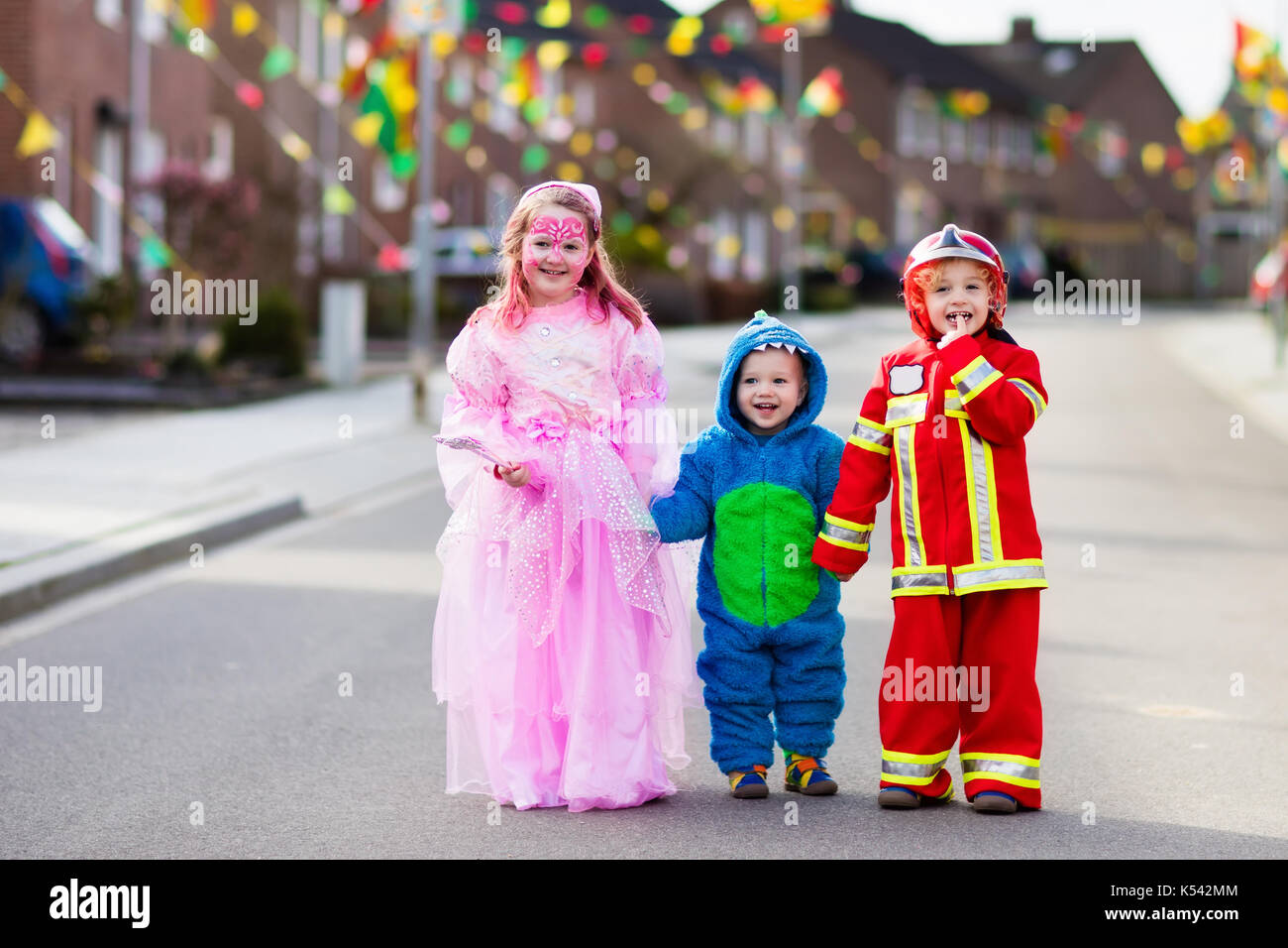 Kids on Halloween trick or treat. Children in Halloween costumes with ...