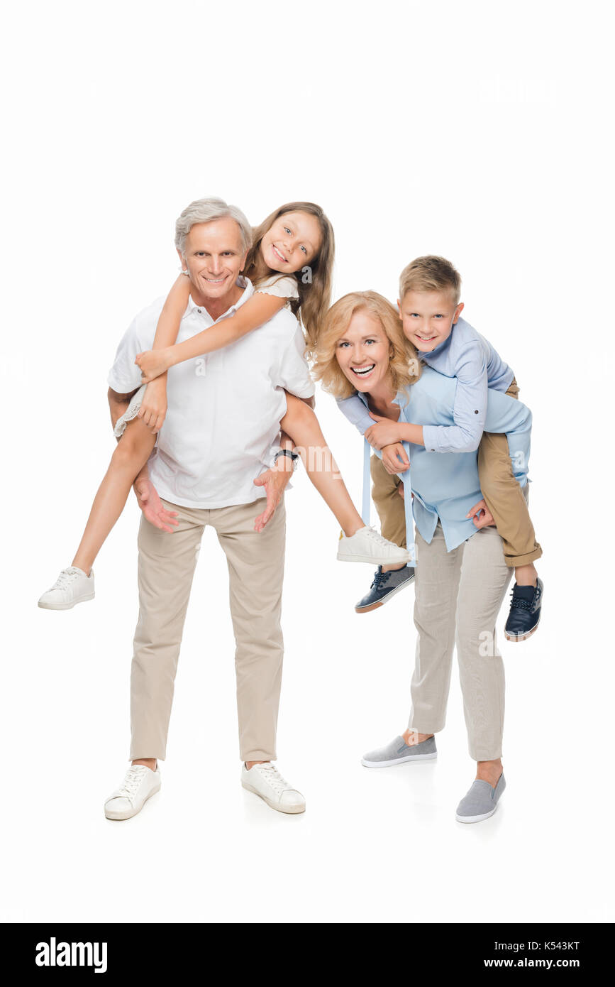 kids piggybacking on grandparents Stock Photo