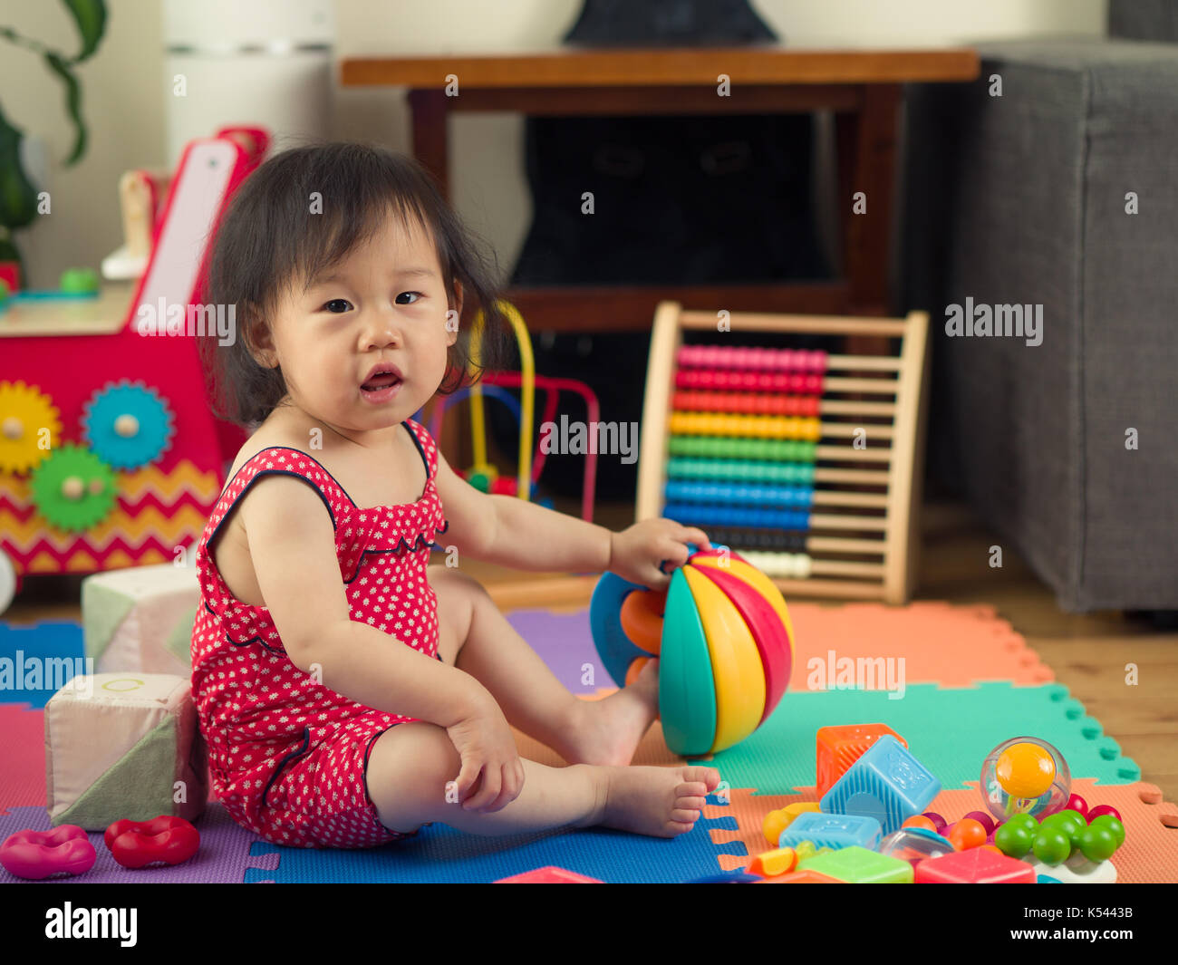 baby girl playing toy at home Stock Photo - Alamy