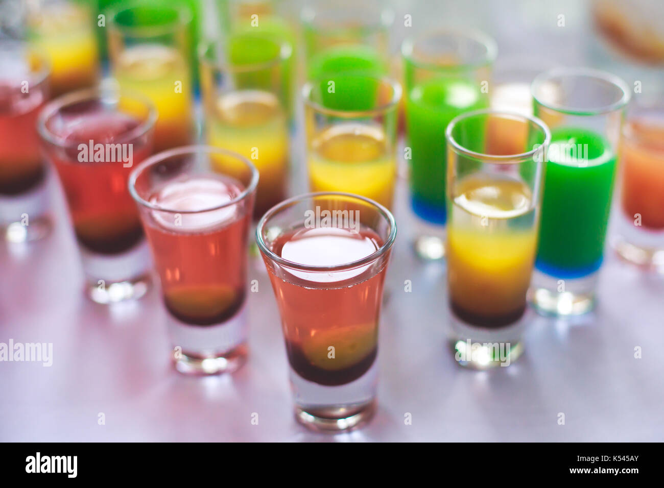 Beautiful line of different coloured alcohol cocktails on a open air ...