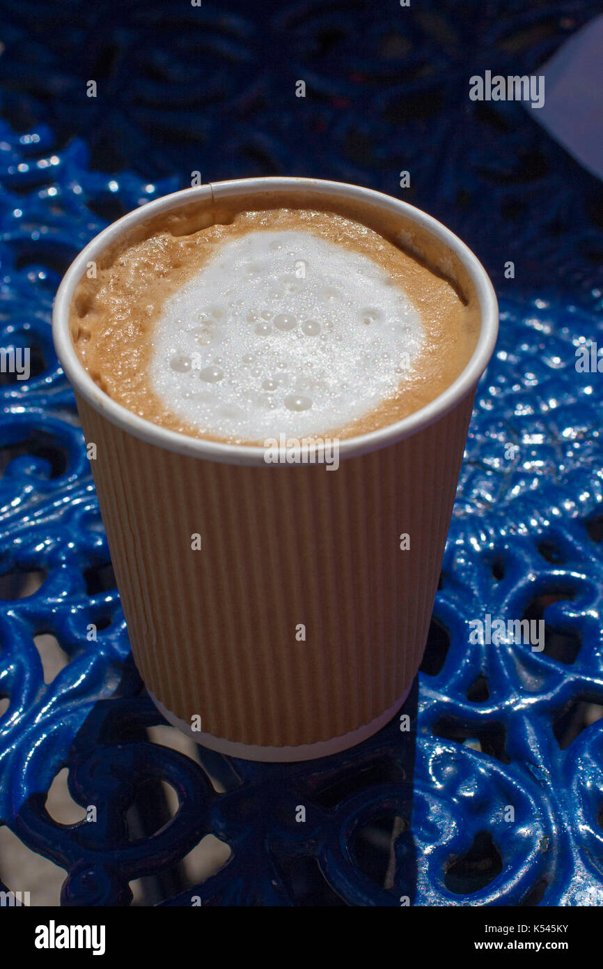 Brown paper cappuccino coffee cup with the lid off, with white foamy ...