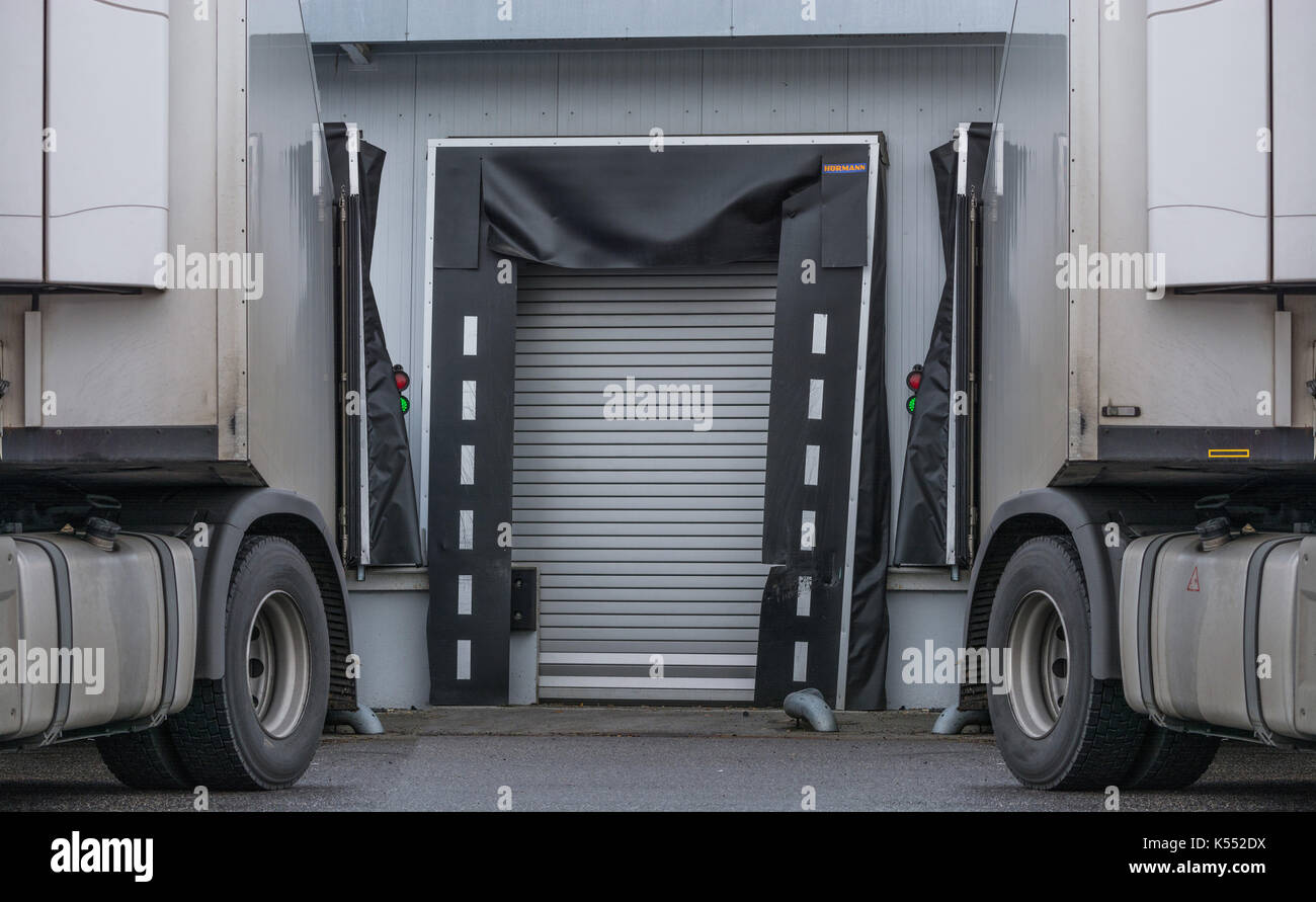 Two Trucks for unloading or loading at the depot of a forwarding company. Stock Photo