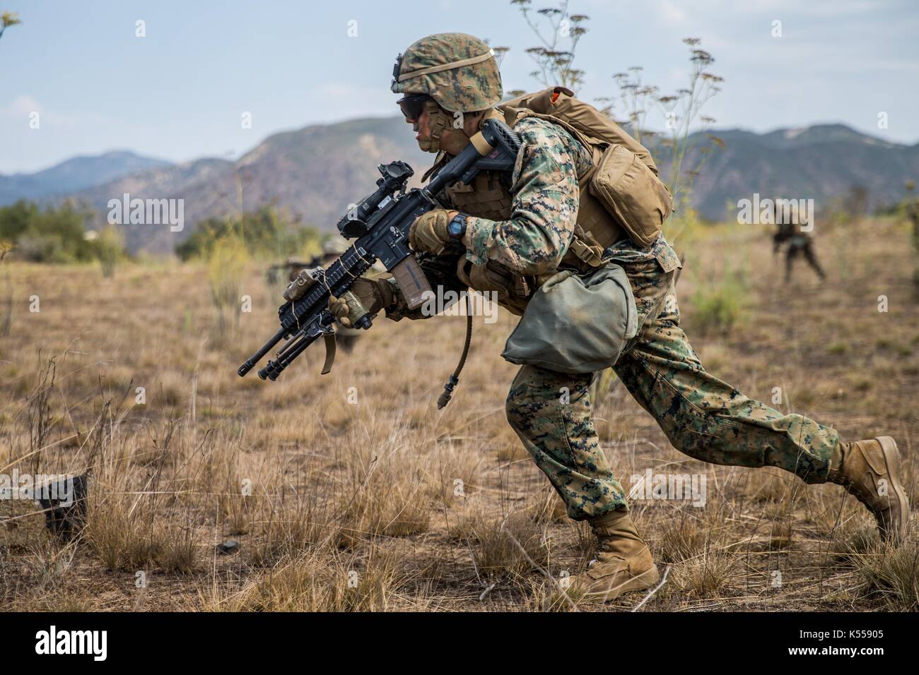 A U.S. Marine with 3rd Battalion, 7th Marines, runs during a simulated squad ambush phase of the 1st Marine Division Infantry Super Squad Competition  Stock Photo