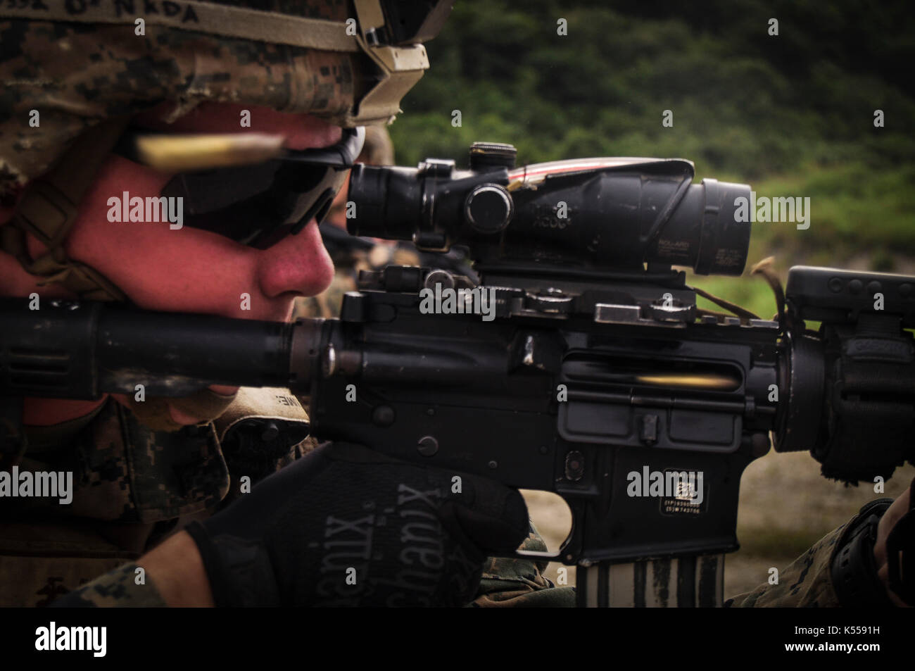 Lance Cpl. Brendan I. Strain, a Valdosta, Georgia native and rifleman assigned to Charlie Company, 1st Battalion, 3rd Marine Regiment, injects rounds  Stock Photo