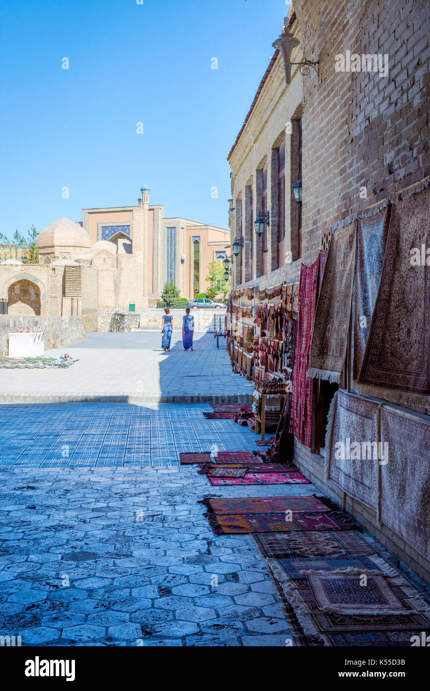 BUKHARA, UZBEKISTAN - SEPTEMBER 4: Traditonal uzbek carpets for sale on the street in downtown of Bukhara. September 2016 Stock Photo