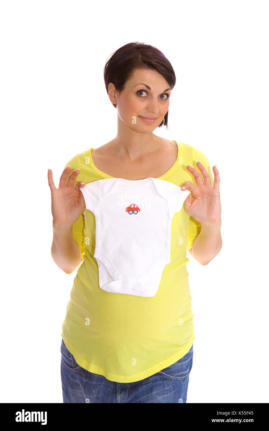 Pregnant woman with baby bump shows baby clothes Stock Photo