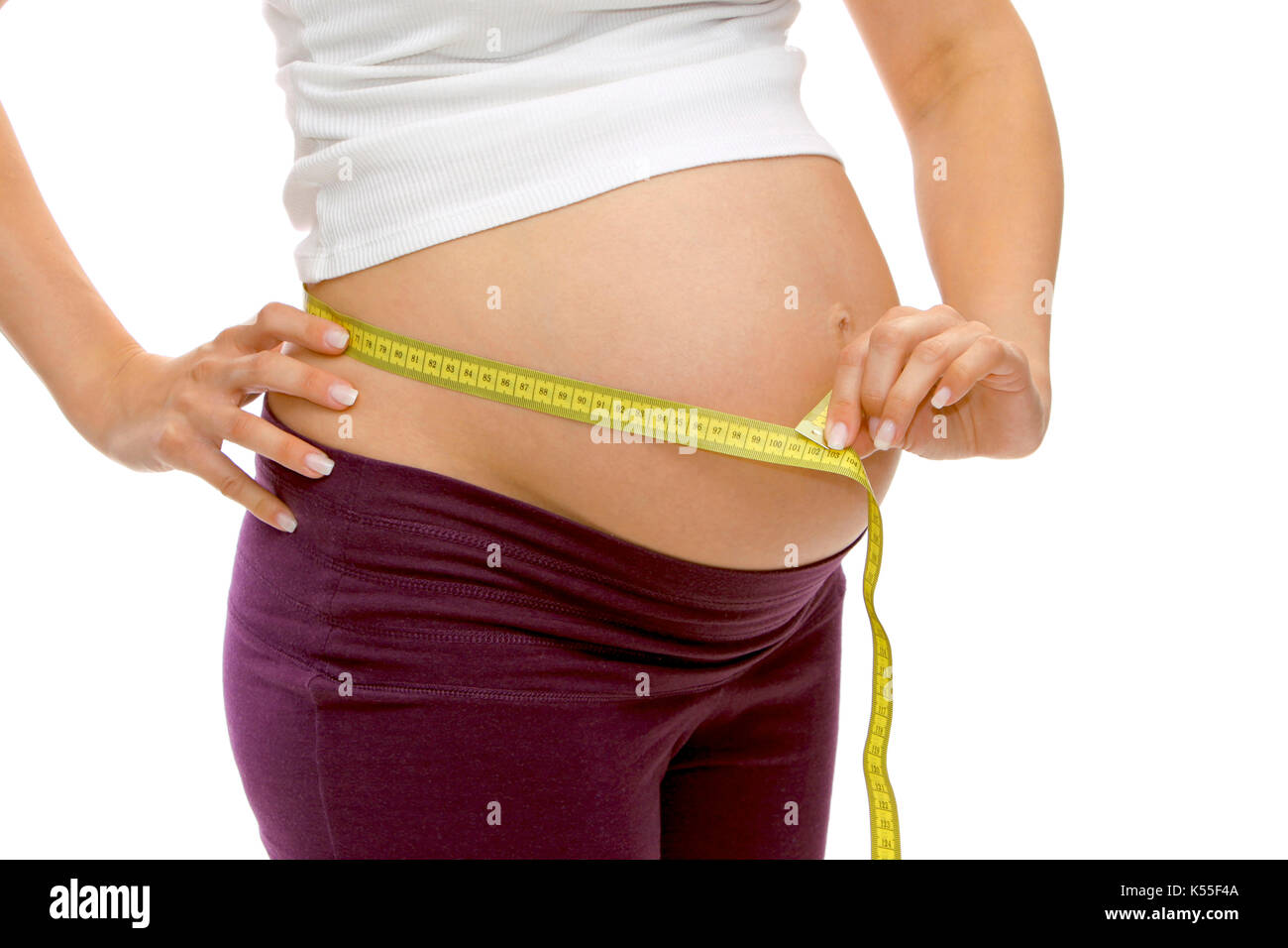 Pregnant woman with measuring tape, measures her belly circumference Stock Photo