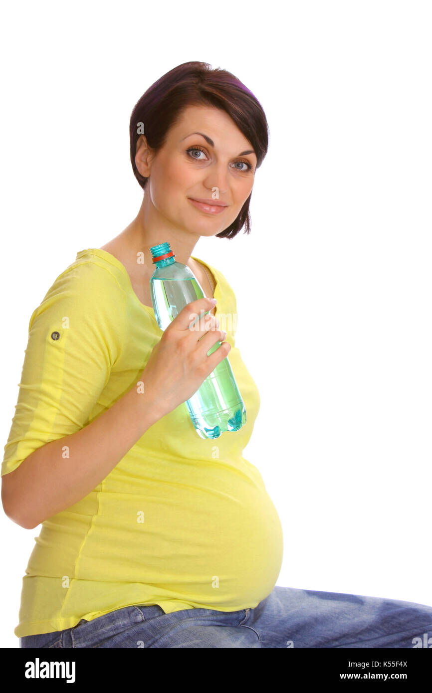 Pregnant woman drinking mineral water from a bottle Stock Photo