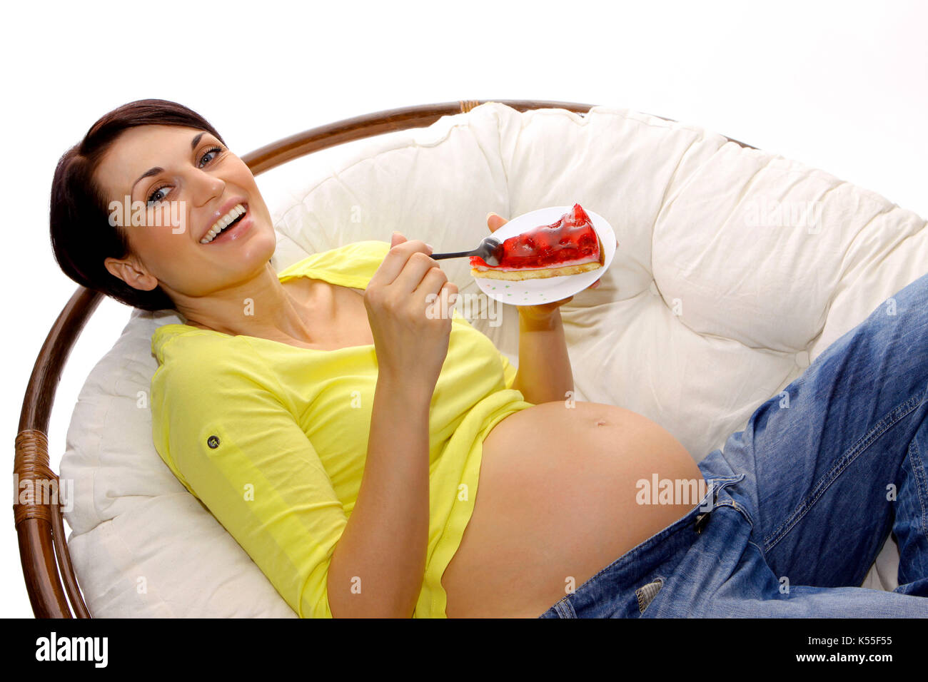Pregnant woman eating a piece of sweet cake Stock Photo