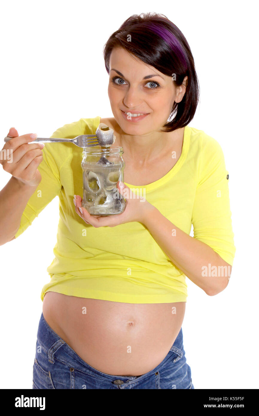 Pregnant woman eats a sour Bismarck herring Stock Photo