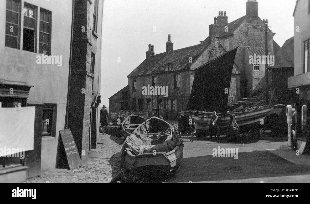 Fishing cobles in the streets of Robin Hood's Bay, North Yorkshire, UK, Circa 1920's Stock Photo