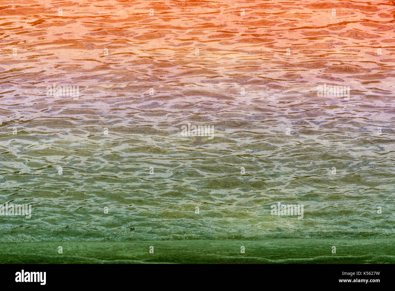 Multicolored wavy water surface as background image. Stock Photo