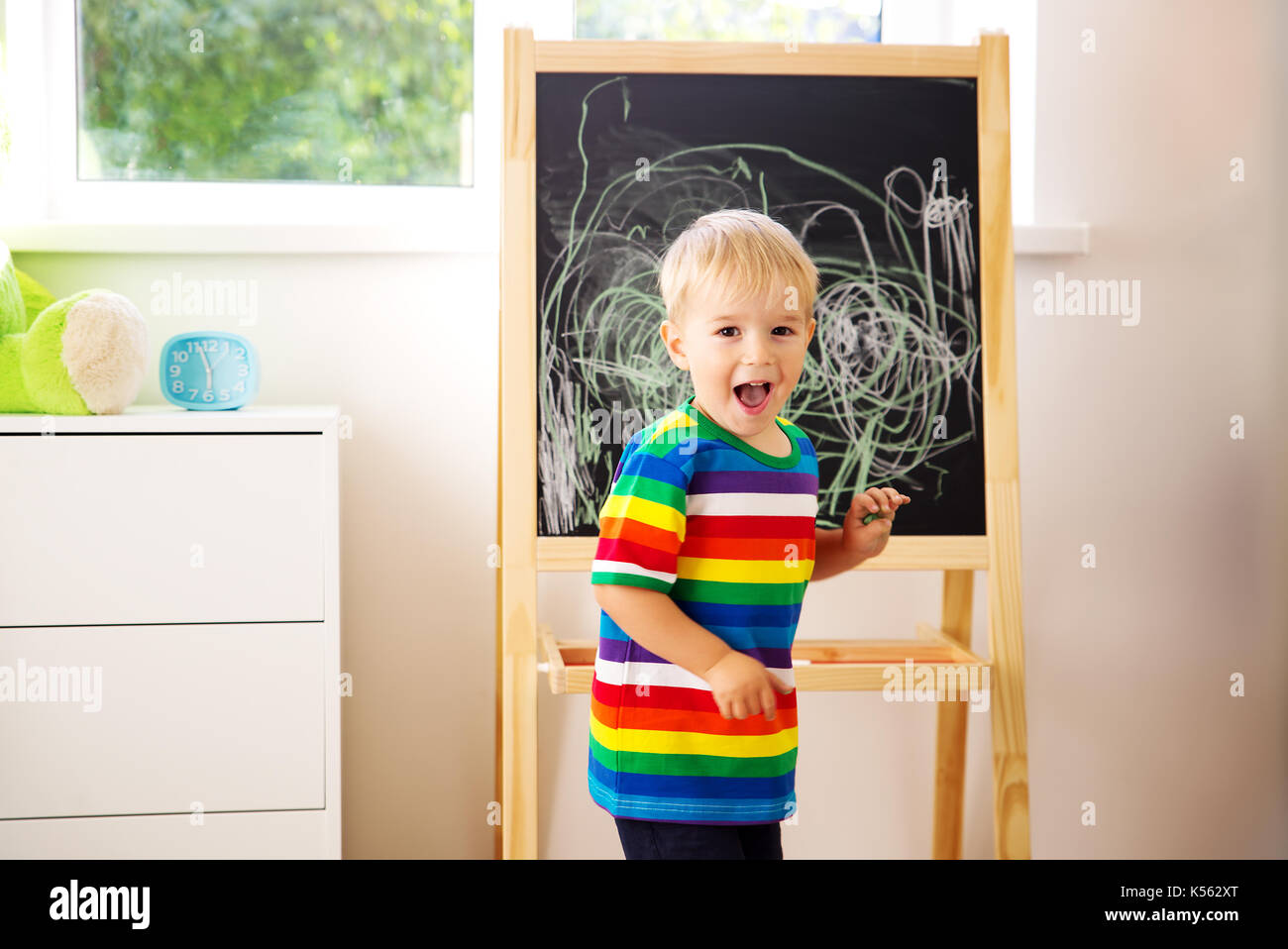 little child drawing on the blackboard Stock Photo