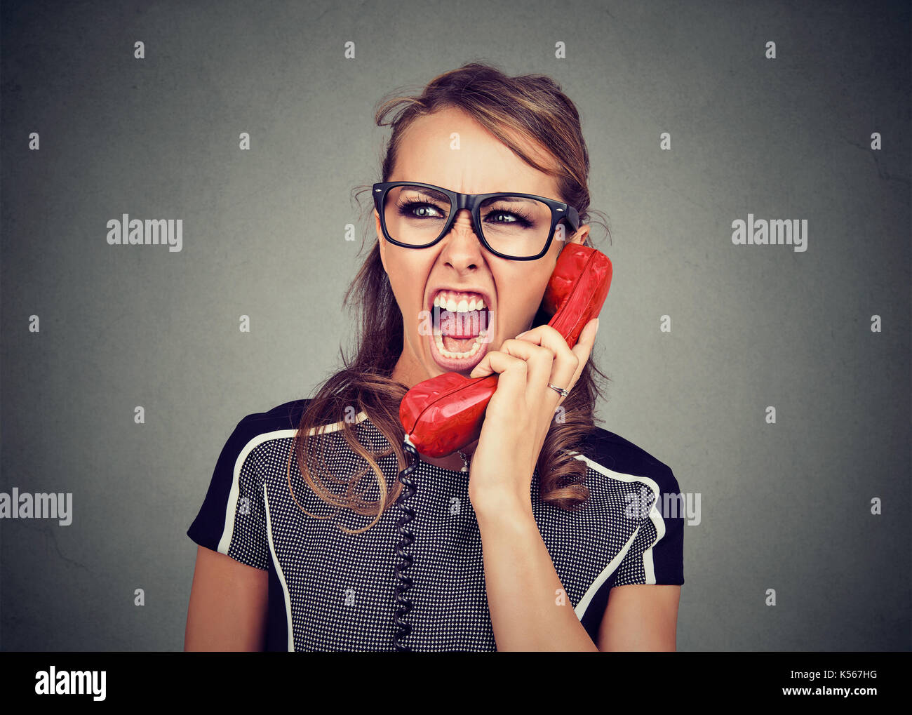 Young woman yelling on the phone Stock Photo