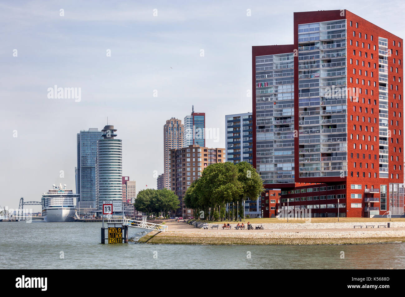 Skyline of Rotterdam Katendrecht with a passenger ship moored at the Wilhelminapier in the background Stock Photo