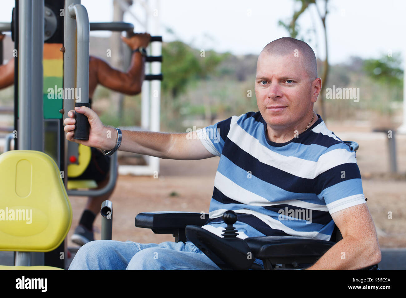 Disabled man working out with trainer. Stock Photo