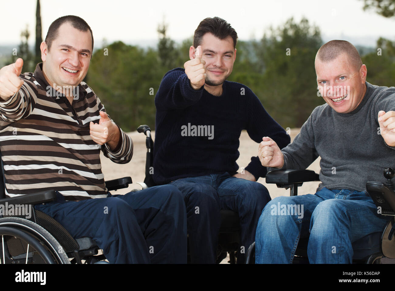 Disabled Happy friends with thumbs up Stock Photo - Alamy