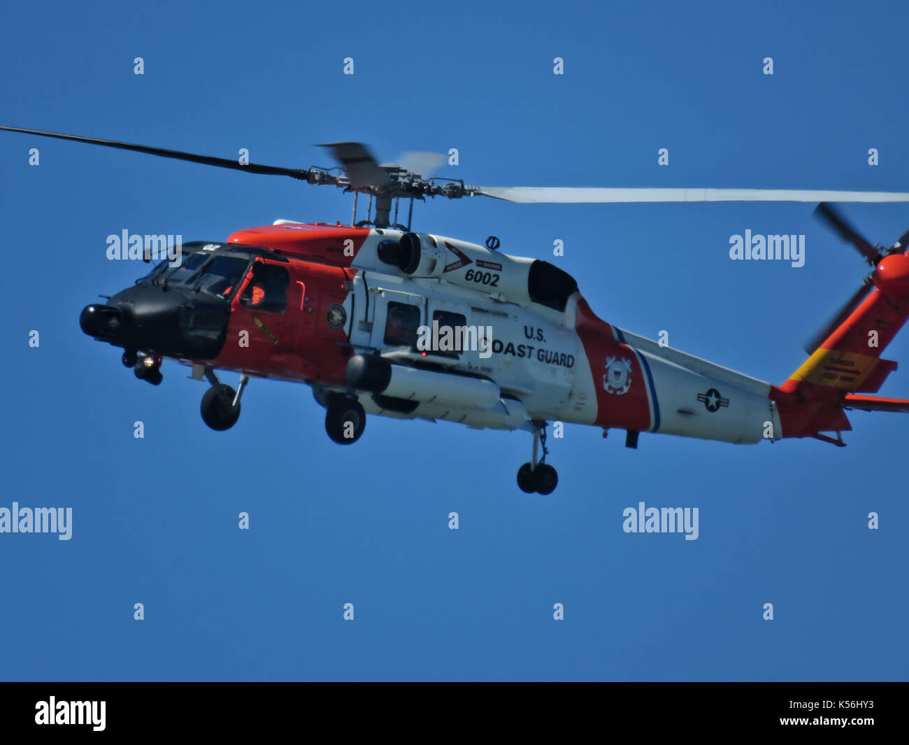 U.S. coast guard helicopter flying near Ocean Shores city in Washington state Stock Photo