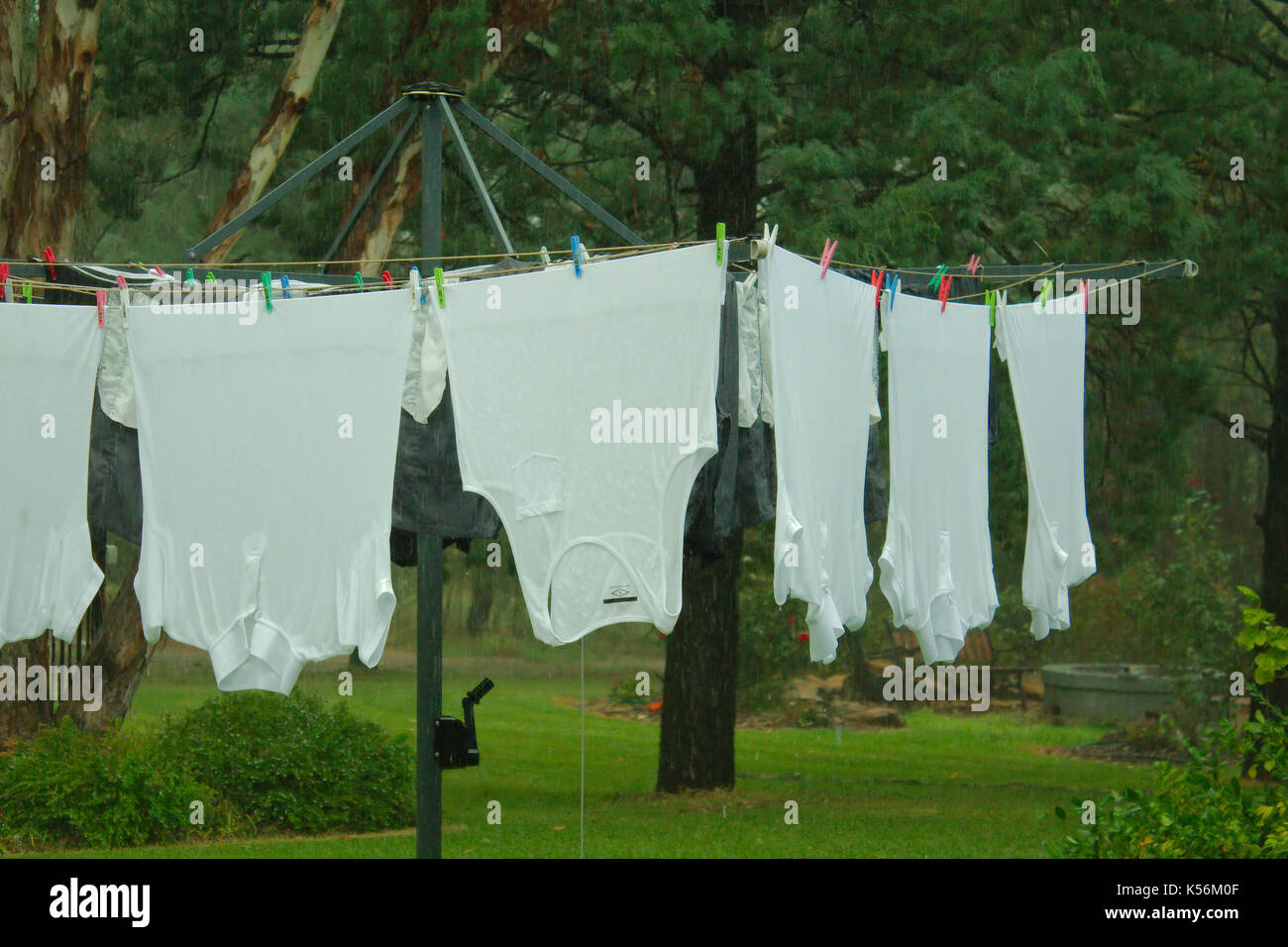 Wet washing hanging on a clothes line during the rain Stock Photo