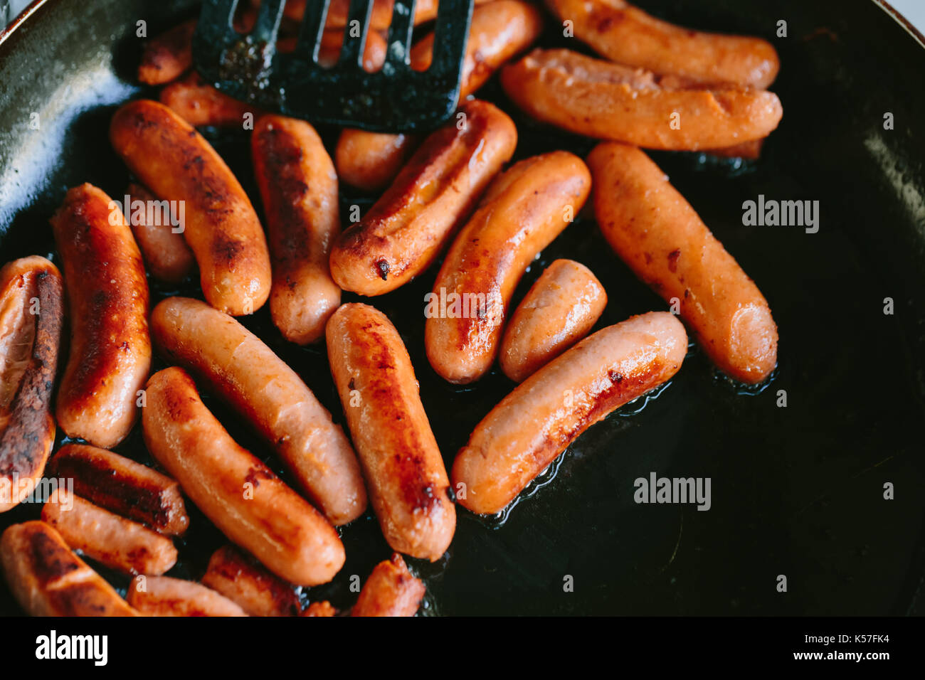 Fried sausages in a frying pan Stock Photo Alamy