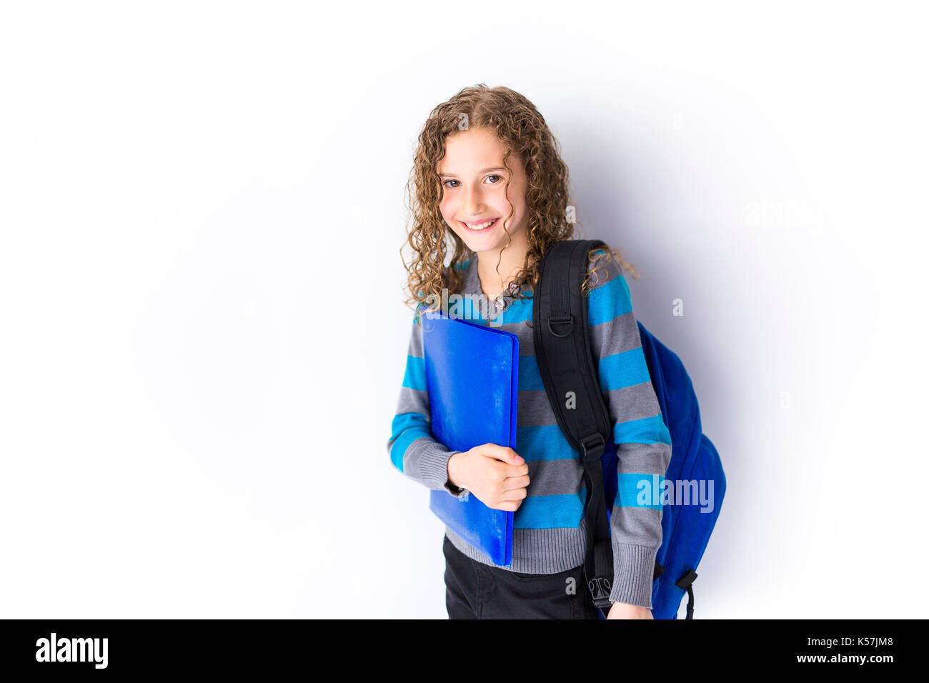 girl of 9 years in a school uniform poses in studio Stock Photo - Alamy