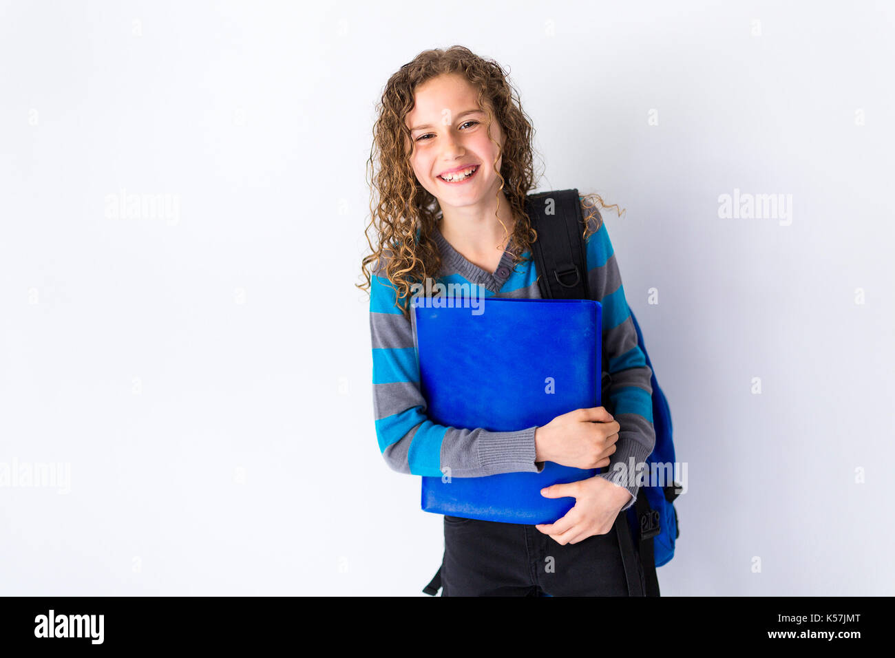 girl of 9 years in a school uniform poses in studio Stock Photo - Alamy