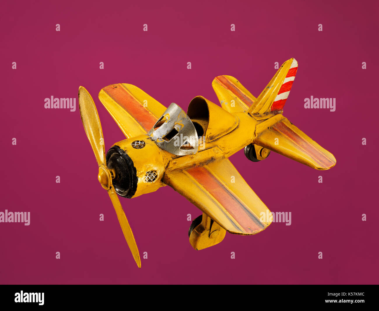 toy plane on dusky pink background Stock Photo