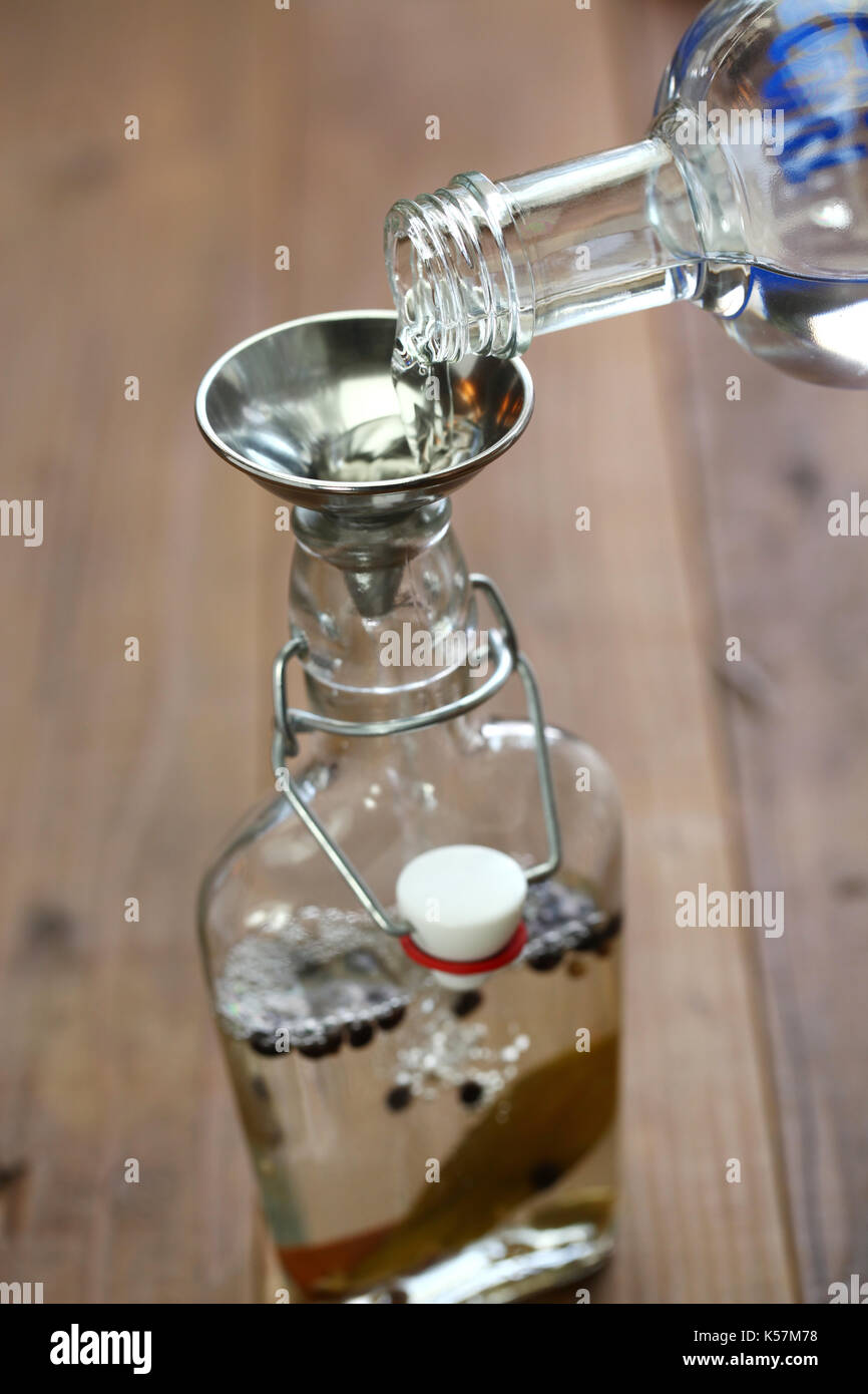making homemade gin, pouring vodka Stock Photo Alamy