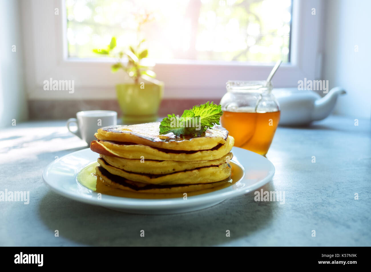 Pancakes heap with sprig of mint and maple syrup Stock Photo