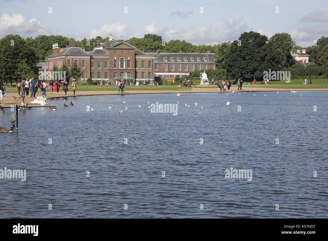 the round pond in hyde park with kensington palace in the distance